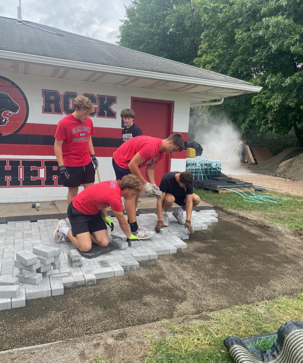 Glen Rock Varsity Football Players helping put in the new stones. 
Photo: Glen Rock Football Instagram